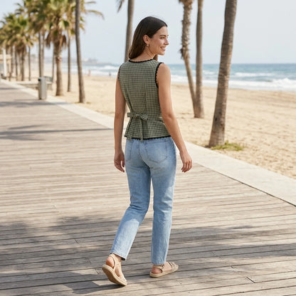 Third natural lifestyle image of a model wearing apricot-boat-neck-plaid-tank-top