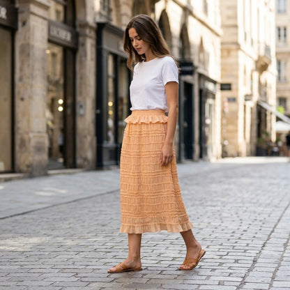 Second natural lifestyle image of a model wearing apricot-elastic-waist-shirred-midi-skirt