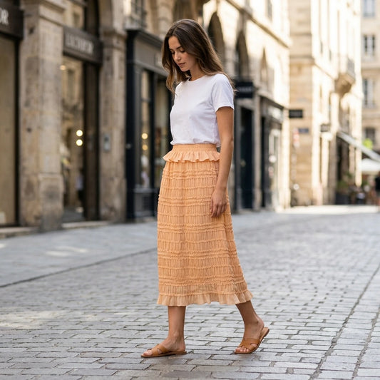 Second natural lifestyle image of a model wearing apricot-elastic-waist-shirred-midi-skirt