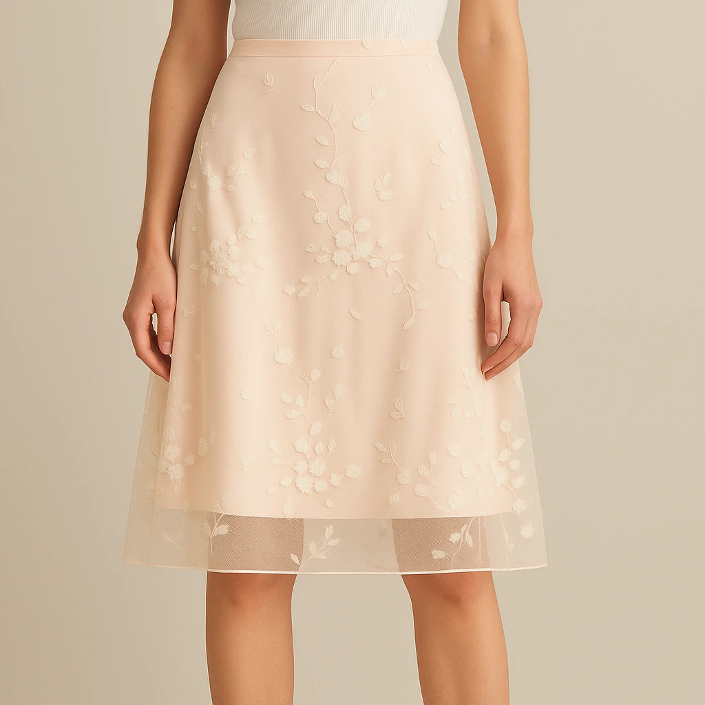 Model wearing Apricot Floral Embroidered Mesh Midi Skirt High Waist A-Line Elegant with close focus on the product