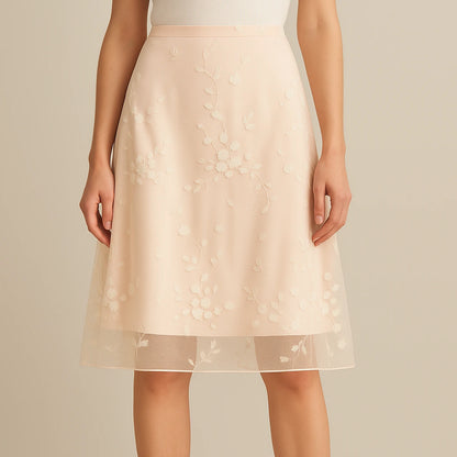 Model wearing Apricot Floral Embroidered Mesh Midi Skirt High Waist A-Line Elegant with close focus on the product