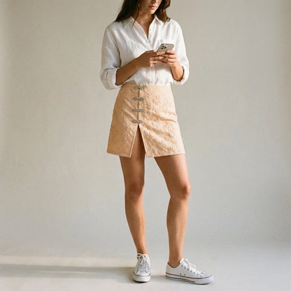 Natural lifestyle image of a model wearing apricot-jacquard-slit-mini-skirt