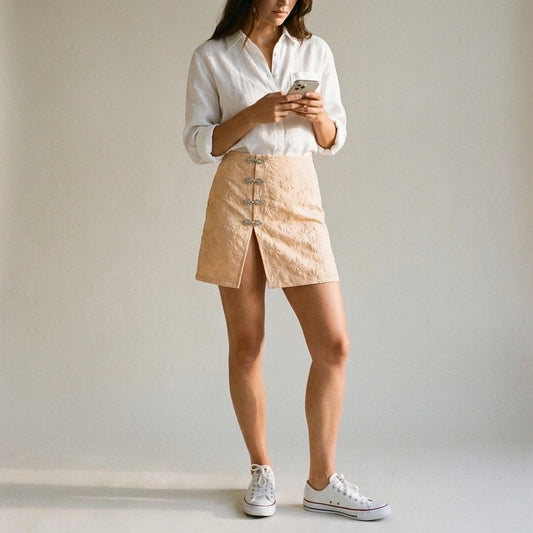 Natural lifestyle image of a model wearing apricot-jacquard-slit-mini-skirt