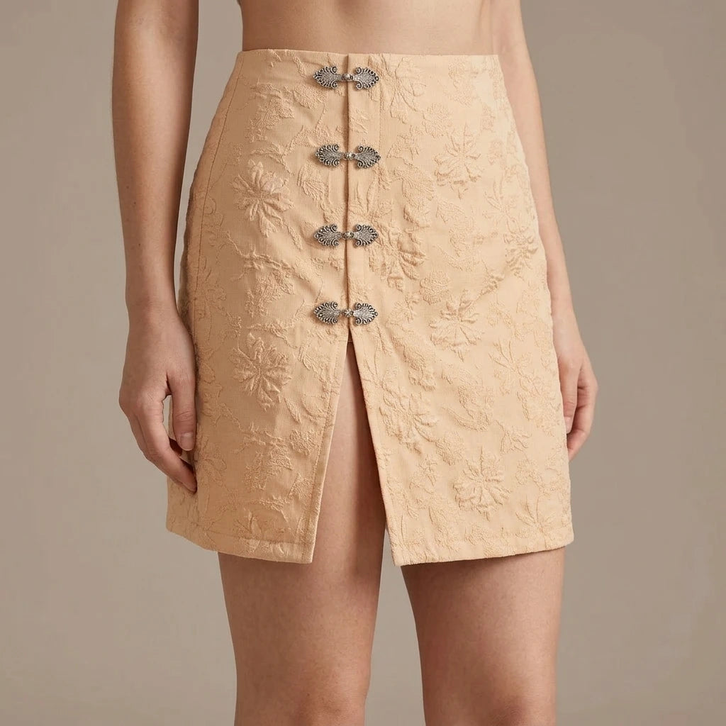 Model wearing apricot-jacquard-slit-mini-skirt with close focus on the product