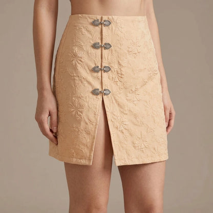Model wearing apricot-jacquard-slit-mini-skirt with close focus on the product