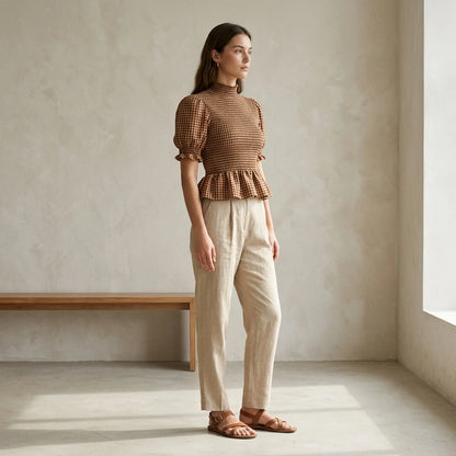 Second natural lifestyle image of a model wearing apricot-lantern-sleeve-shirred-plaid-tee