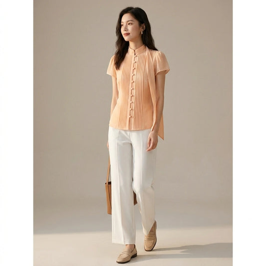 Natural lifestyle image of a model wearing apricot-mock-neck-button-chiffon-blouse