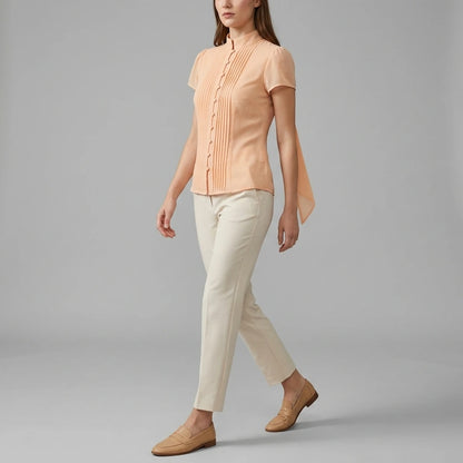Second natural lifestyle image of a model wearing apricot-mock-neck-button-chiffon-blouse