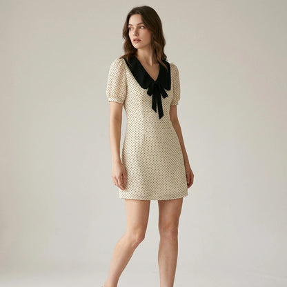 Second natural lifestyle image of a model wearing apricot-polka-dot-contrasting-mini-dress
