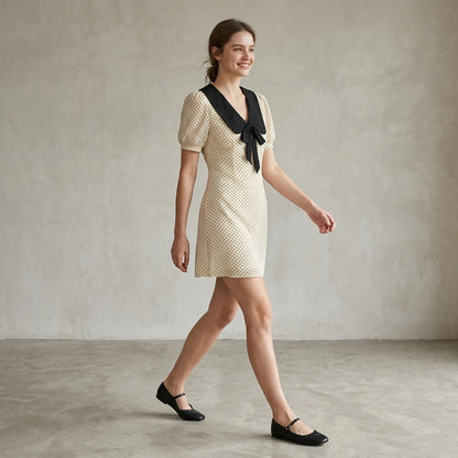 Third natural lifestyle image of a model wearing apricot-polka-dot-contrasting-mini-dress