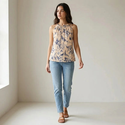 Third natural lifestyle image of a model wearing apricot-ruffled-floral-tank-top