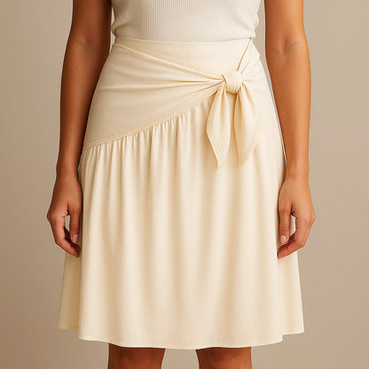 Model wearing Apricot Spliced Tie Midi Skirt High Waist A-Line Casual with close focus on the product