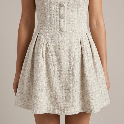 Model wearing Apricot Textured Sleeveless Mini Dress with close focus on the product