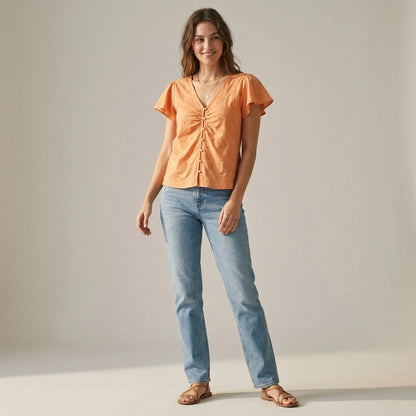 Natural lifestyle image of a model wearing Apricot V Neck Embroidery Tee