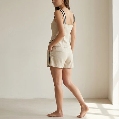 Second natural lifestyle image of a model wearing beige-contrasting-button-shorts