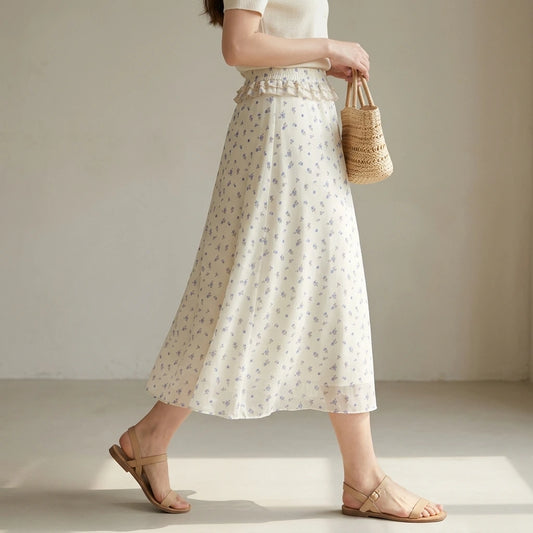 Third natural lifestyle image of a model wearing beige-floral-chiffon-midi-skirt