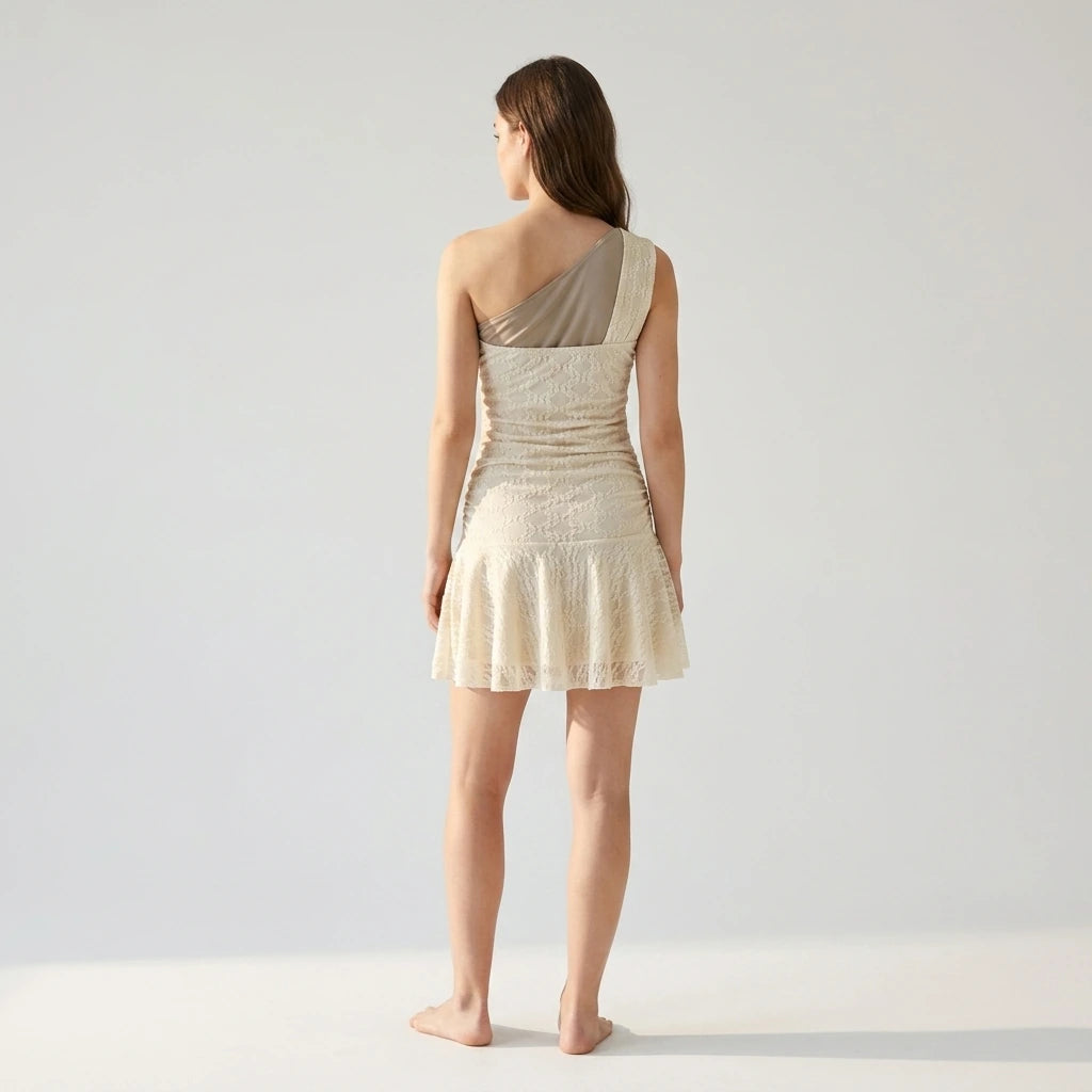 Natural lifestyle image of a model wearing beige-lace-one-shoulder-mini-dress