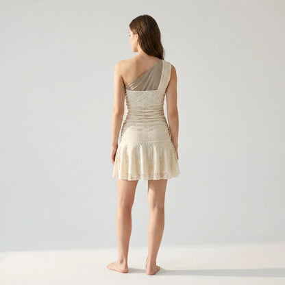 Natural lifestyle image of a model wearing beige-lace-one-shoulder-mini-dress
