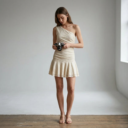 Third natural lifestyle image of a model wearing beige-lace-one-shoulder-mini-dress