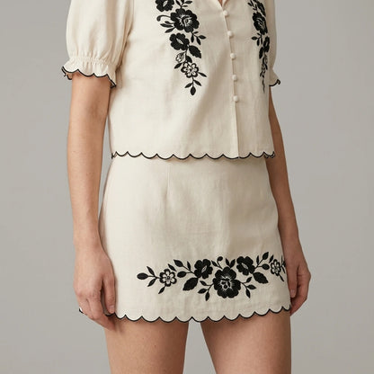 Model wearing Beige Puffed Sleeve Embroidery Contrasting Blouse with close focus on the product