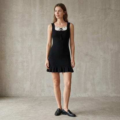 Third natural lifestyle image of a model wearing black-contrasting-sweater-dress