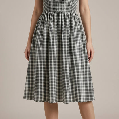 Model wearing black-v-neck-plaid-midi-dress with close focus on the product