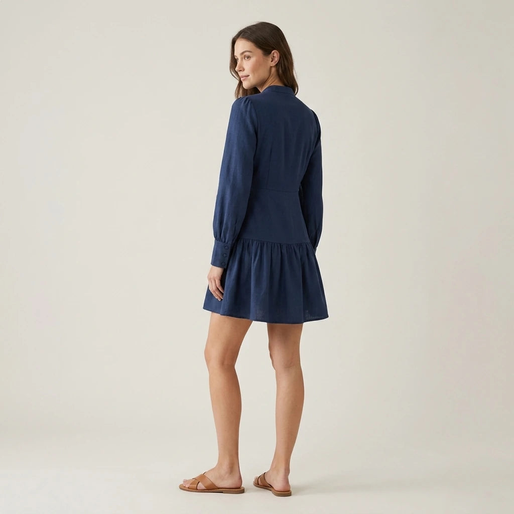 Third natural lifestyle image of a model wearing blue-a-line-pleated-mini-dress