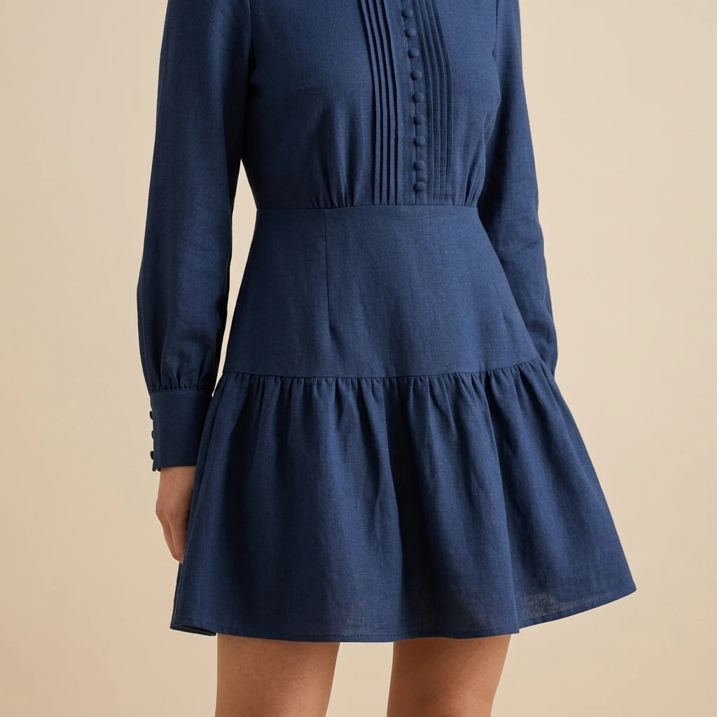 Model wearing blue-a-line-pleated-mini-dress with close focus on the product