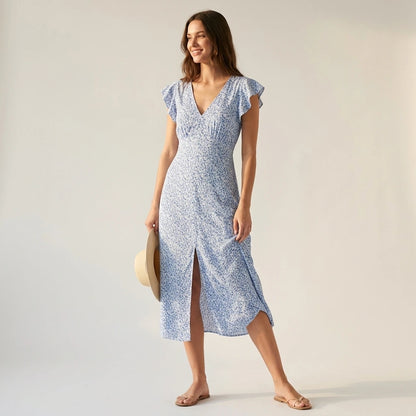 Natural lifestyle image of a model wearing blue-v-neck-tie-floral-maxi-dress