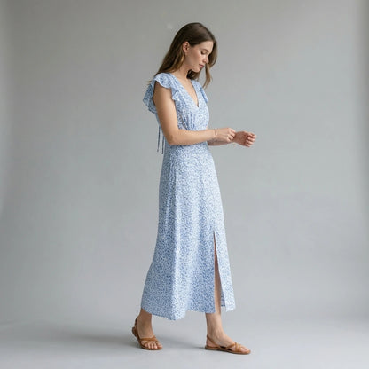 Third natural lifestyle image of a model wearing blue-v-neck-tie-floral-maxi-dress