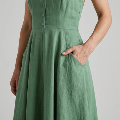 Model wearing green-halter-button-pockets-midi-dress with close focus on the product