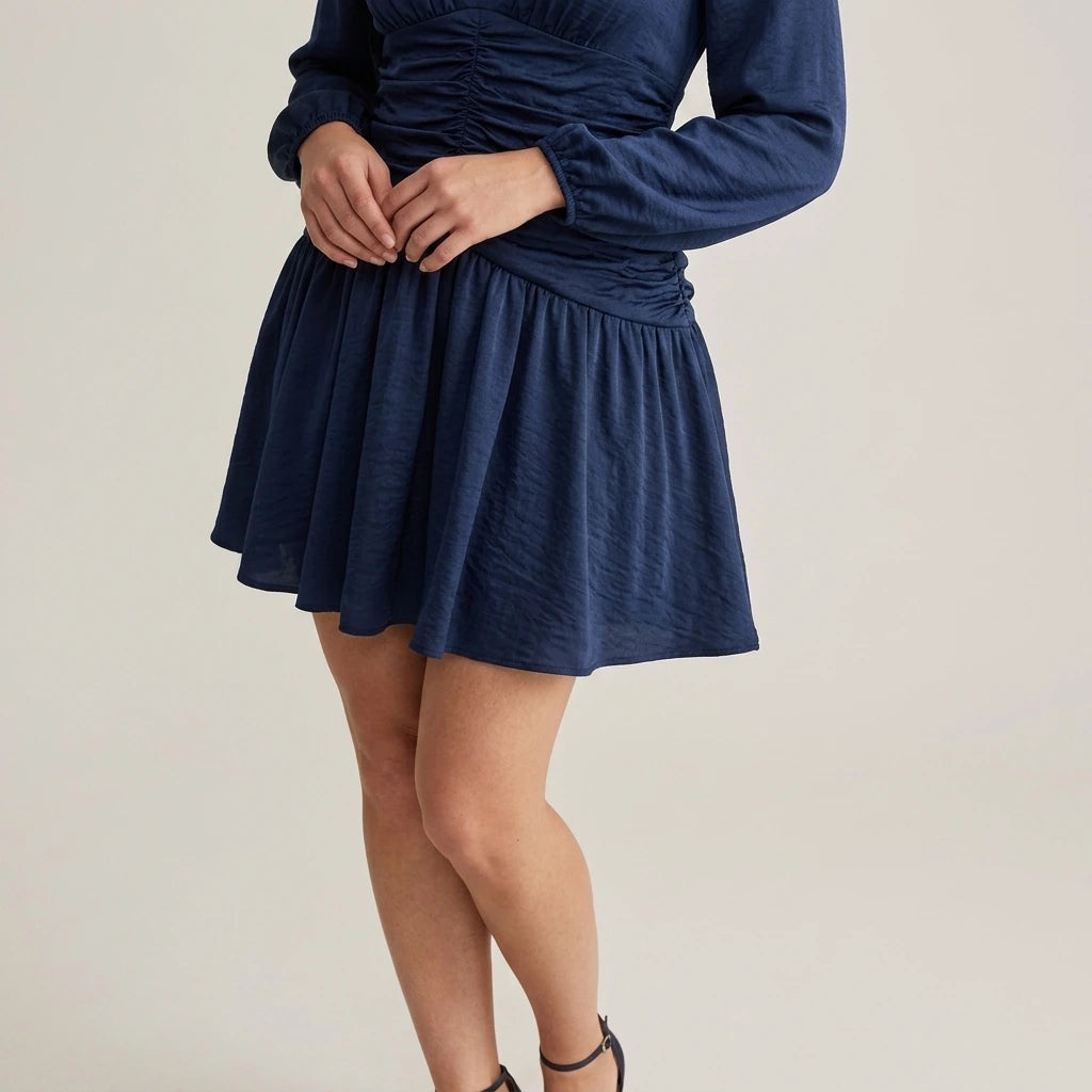 Model wearing navy-ruched-a-line-mini-dress with close focus on the product