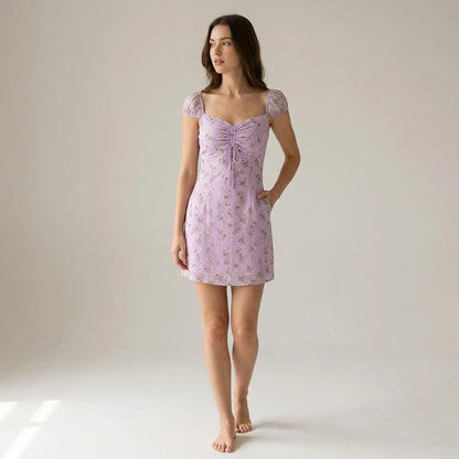 Second natural lifestyle image of a model wearing purple-sweetheart-neck-jacquard-mini-dress