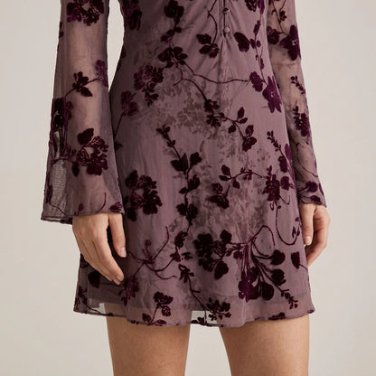 Model wearing purple-v-neck-floral-mini-dress with close focus on the product