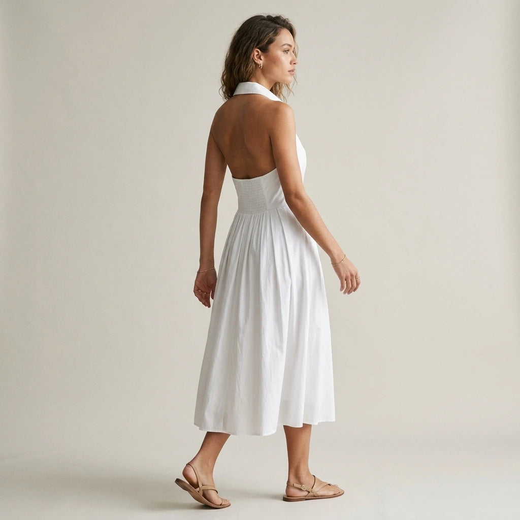 Second natural lifestyle image of a model wearing The White Collared Twist Backless Midi Dress