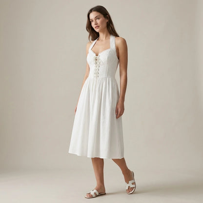 Third natural lifestyle image of a model wearing white-embroidery-a-line-halter-midi-dress