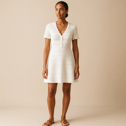 Third natural lifestyle image of a model wearing White Cut Out V Neck Sweater Dress Short Sleeve Ribbed Effortless Summer